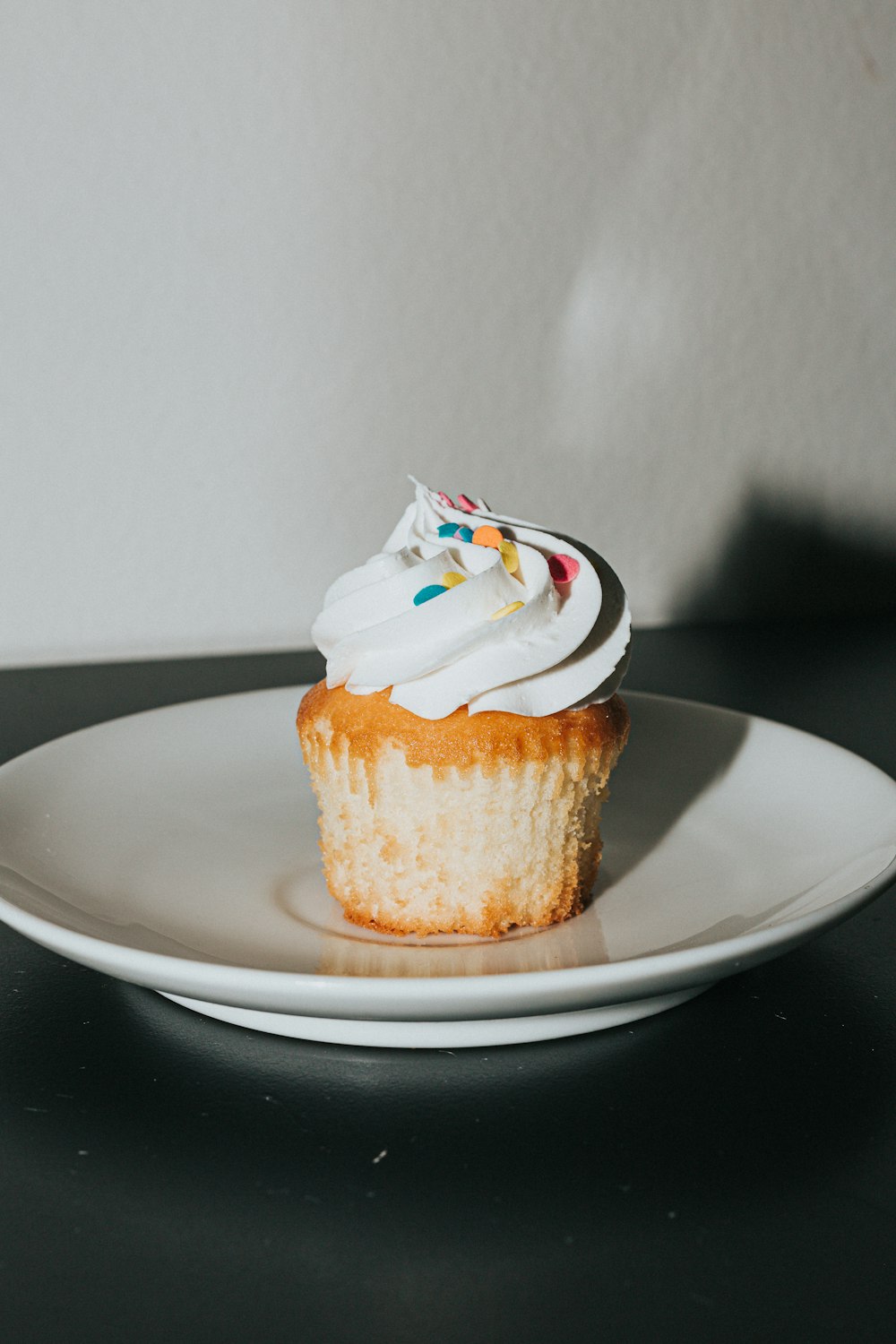 brown and white cupcake on white ceramic plate