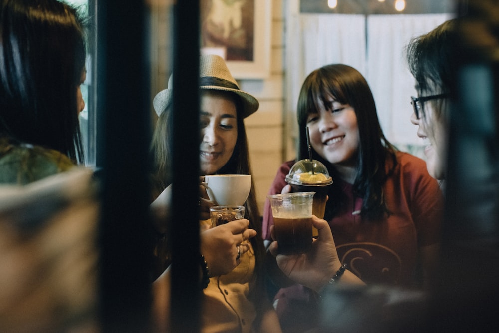 woman in black shirt holding clear drinking glass