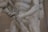 A detailed close-up view of a marble sculpture depicting a dynamic and intricate scene featuring human figures. The focus is on the interlocking hands and muscular arms, emphasizing the tension and movement captured in the stone.