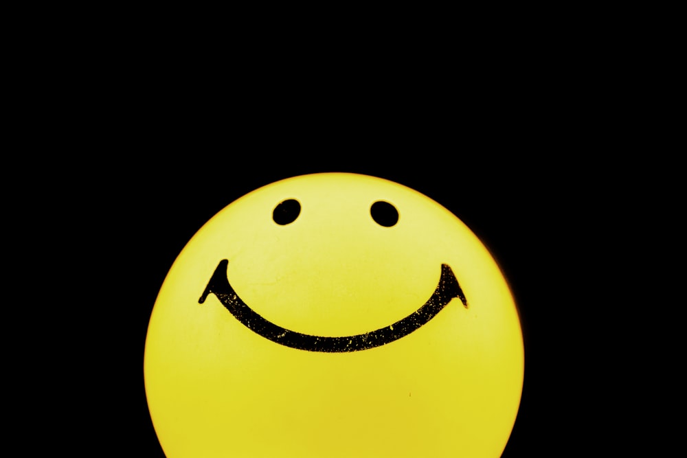 yellow and black smiley emoji