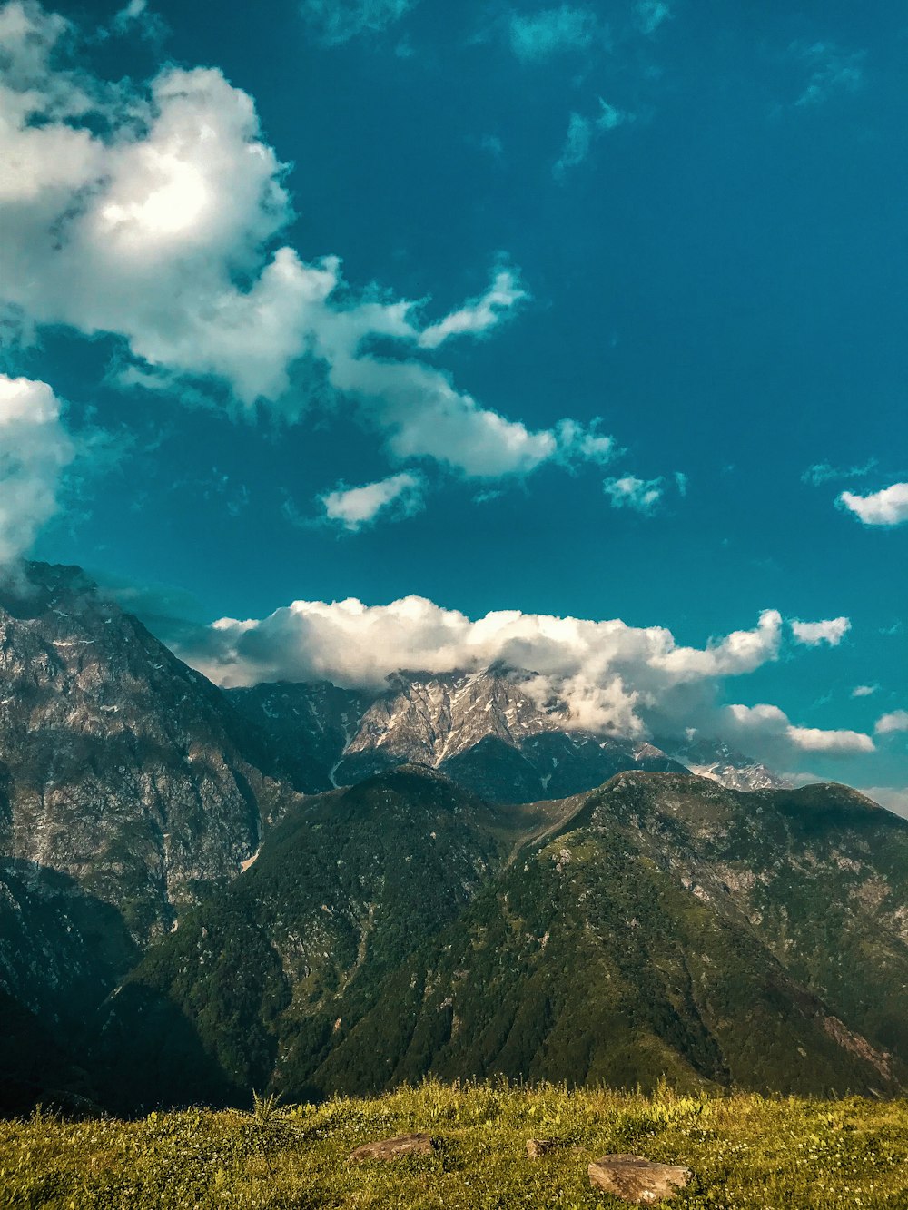 green and brown mountain under blue sky and white clouds during daytime