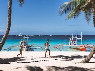 woman in pink bikini walking on beach during daytime