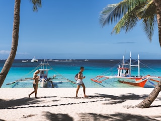 woman in pink bikini walking on beach during daytime