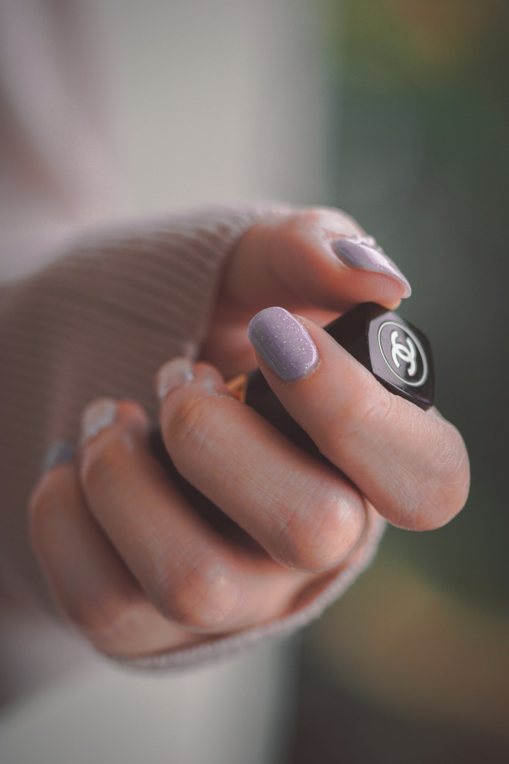 person holding black and silver ring