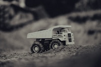 white and black truck on brown sand
