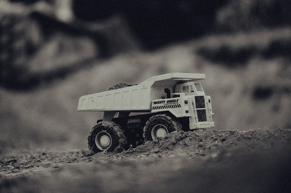 white and black truck on brown sand