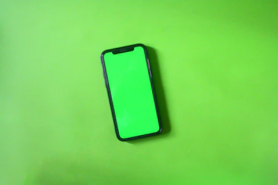 A sleek black smartphone with a glowing green screen displaying the TechMovil logo.
