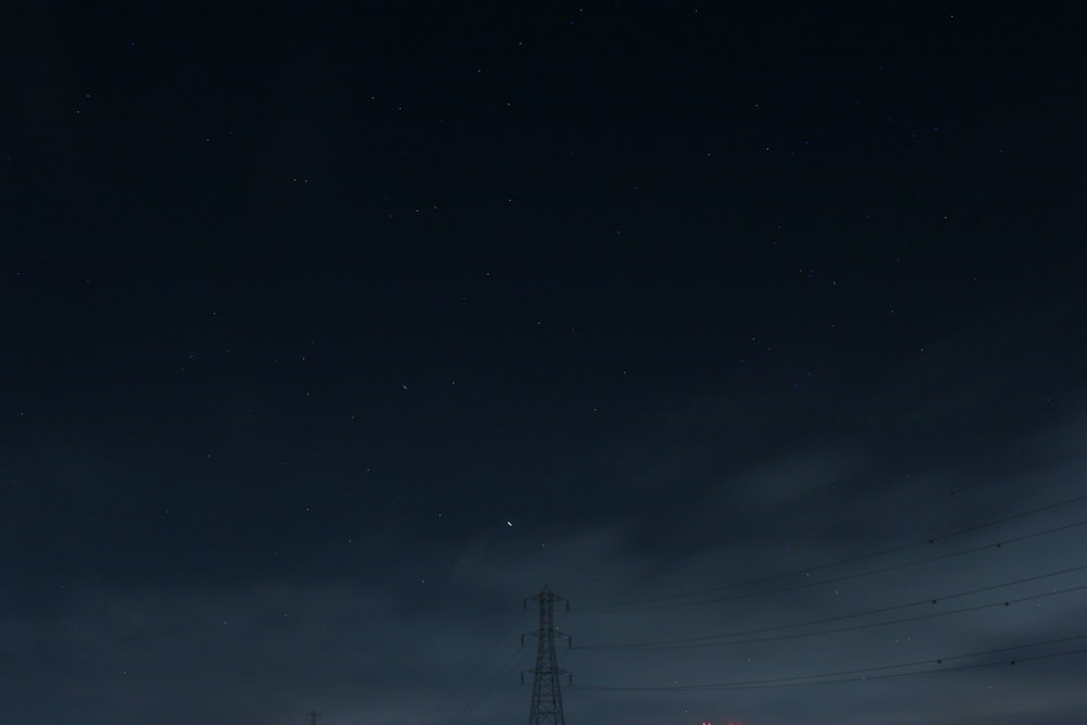 black electric post under dark sky