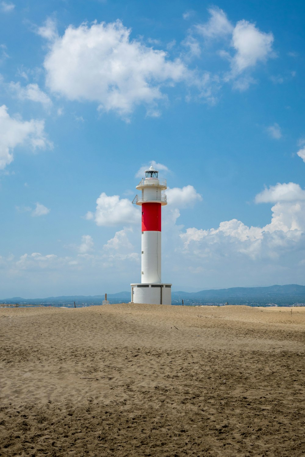 white and red lighthouse under blue sky during daytime