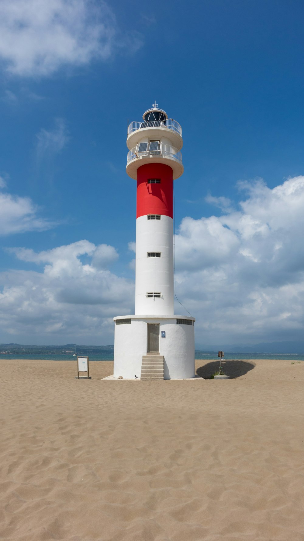 white and red lighthouse under blue sky during daytime