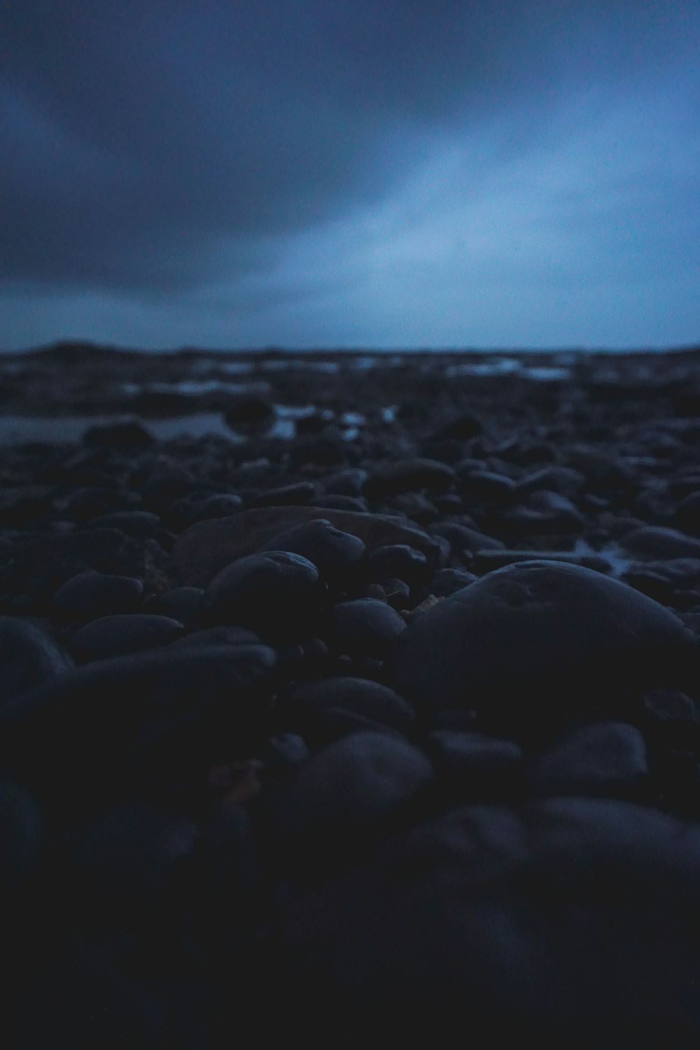 black rocks on the beach during daytime