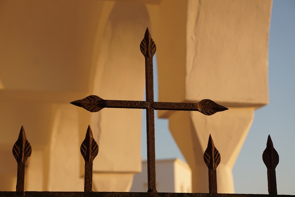 black wooden cross on brown wooden fence