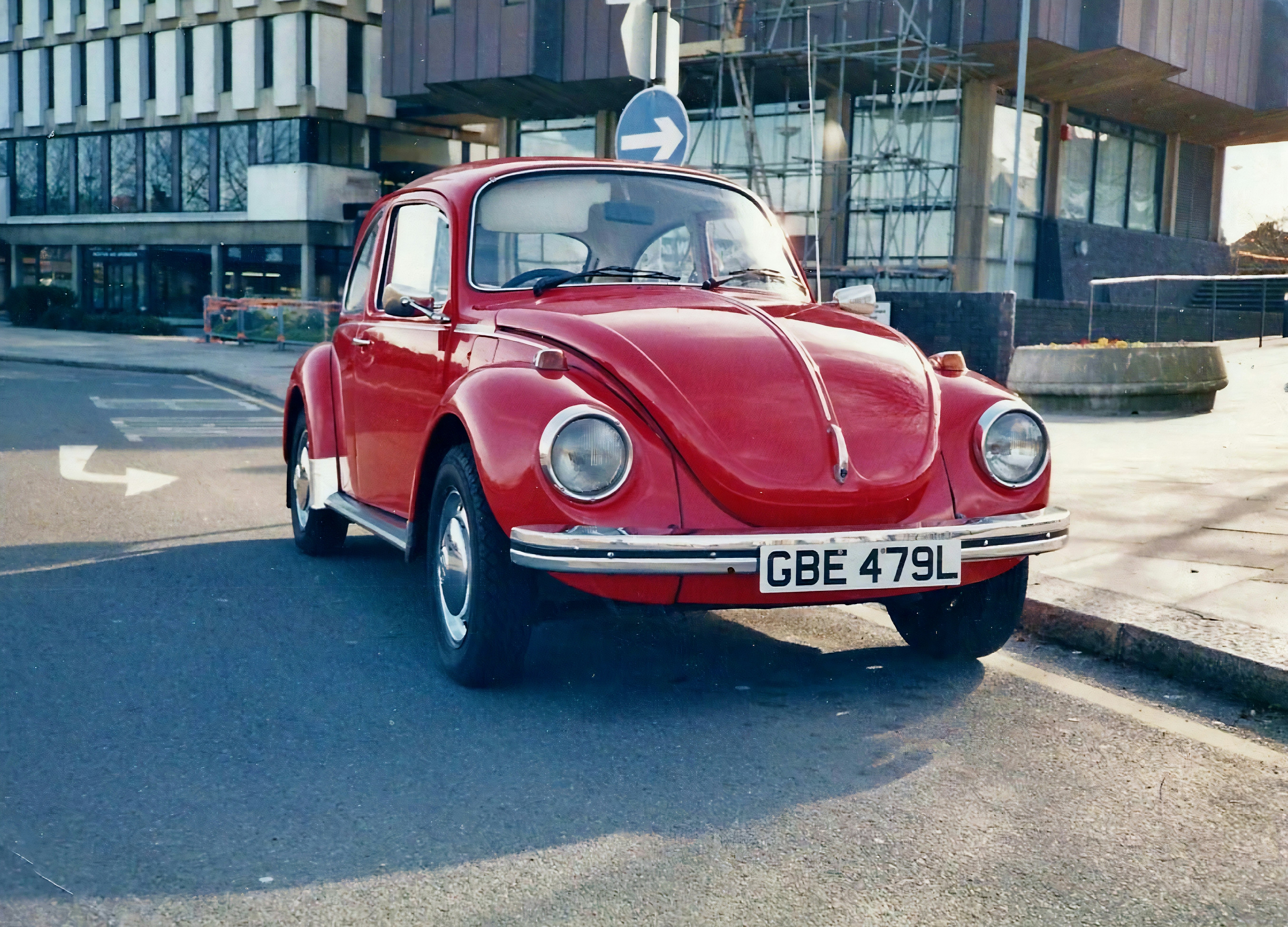 red classic car parked on street during daytime