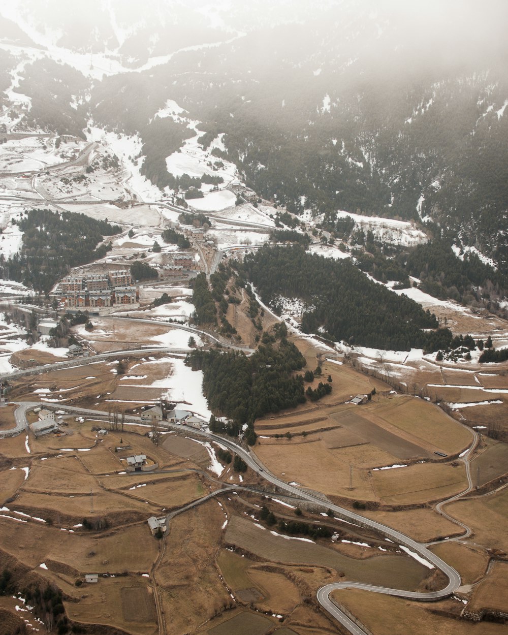 aerial view of brown field and mountains during daytime