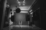 grayscale photo of music stand with drum kit