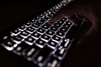 person holding black computer keyboard