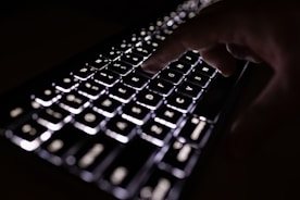 person holding black computer keyboard