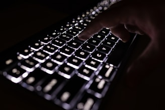 person holding black computer keyboard