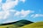 A serene pastel painting of a tranquil landscape with soft clouds and gentle hills.