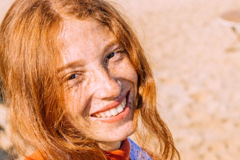 woman in blue and red shirt smiling