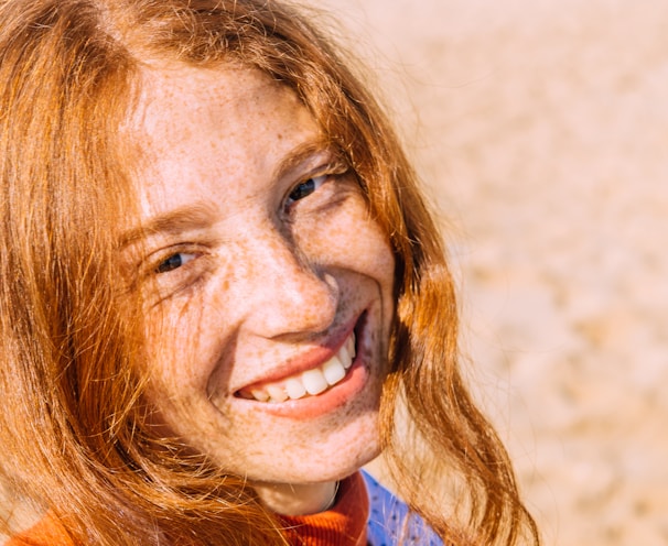 woman in blue and red shirt smiling