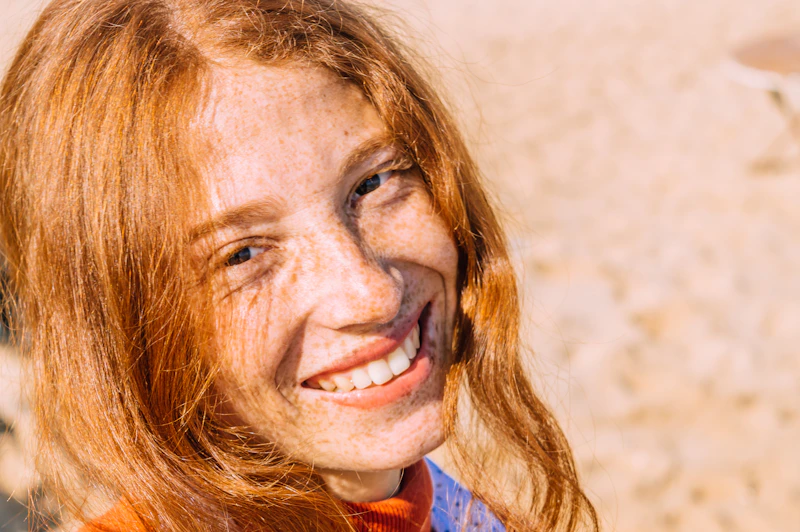 smiling woman in a blue and red shirt