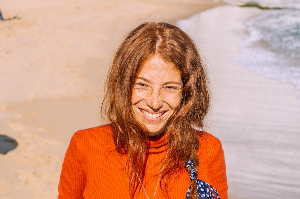 woman in orange cardigan smiling
