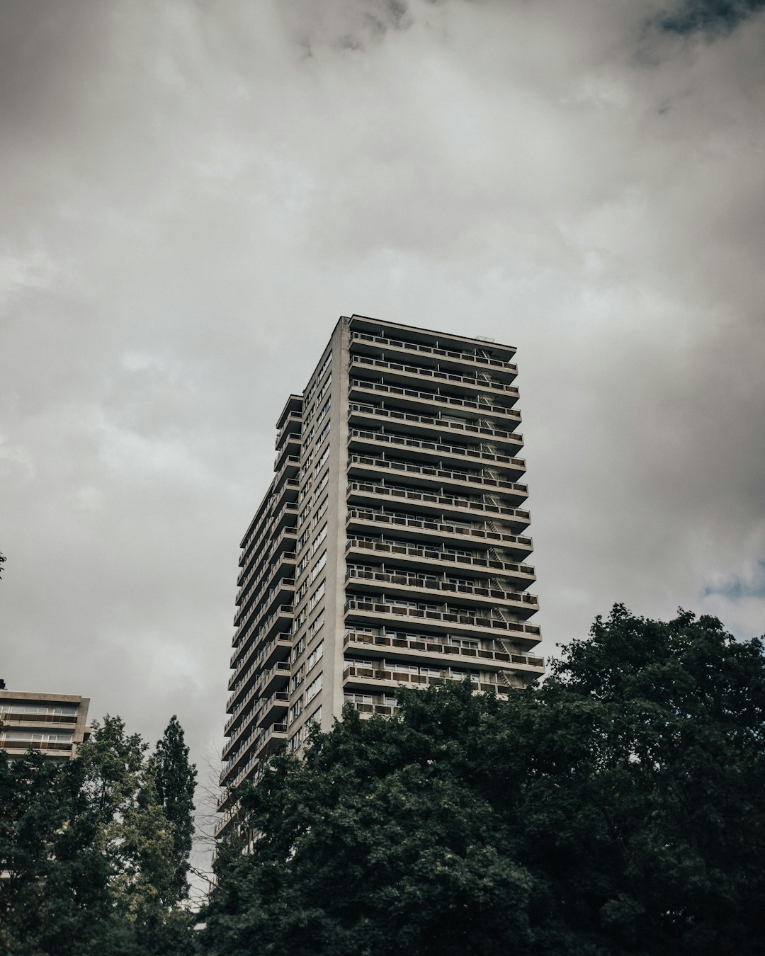 brown concrete building near green trees during daytime