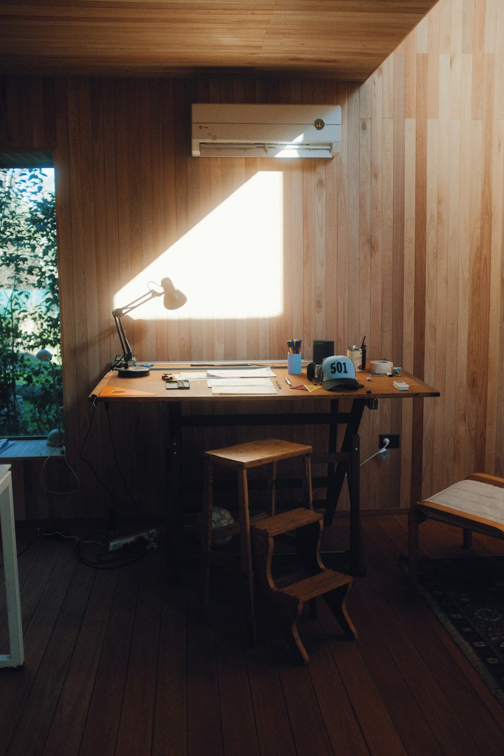 brown wooden table with black laptop computer on top