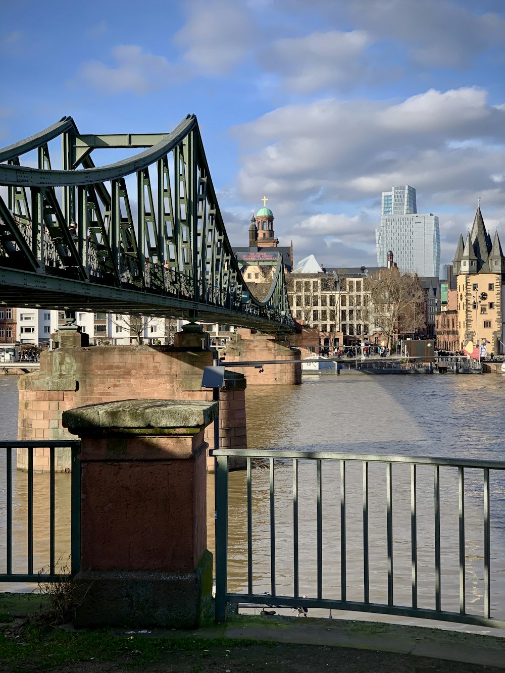 bridge over water near city buildings during daytime