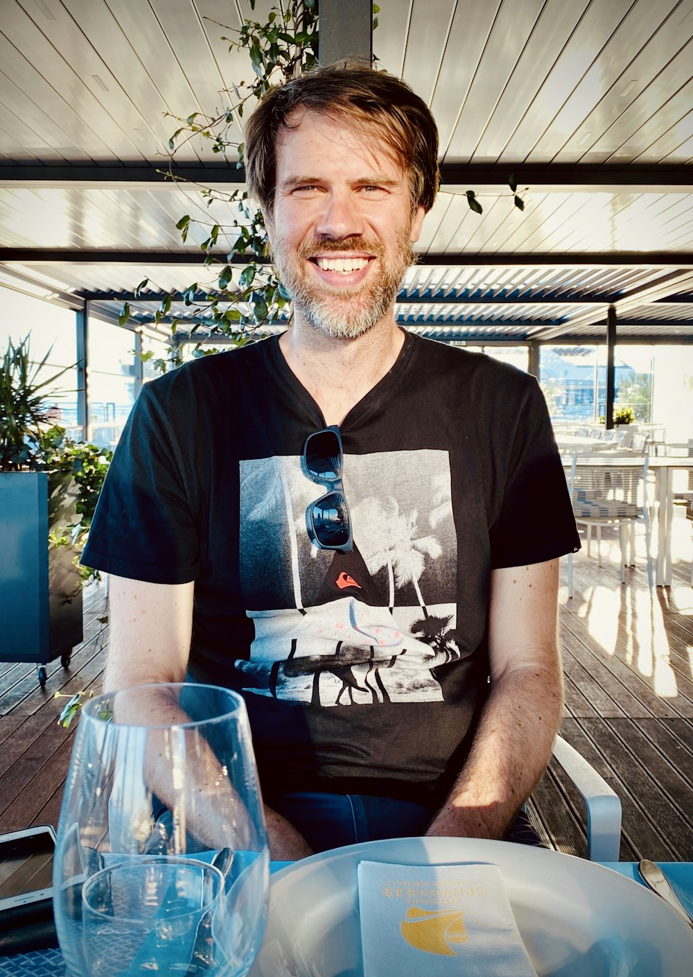 man in black crew neck t-shirt sitting on chair