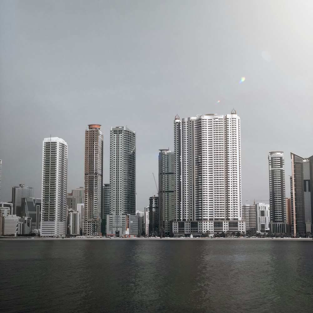 city skyline across body of water during daytime