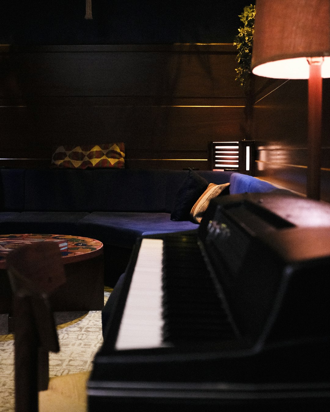 black and white piano near brown wooden chair