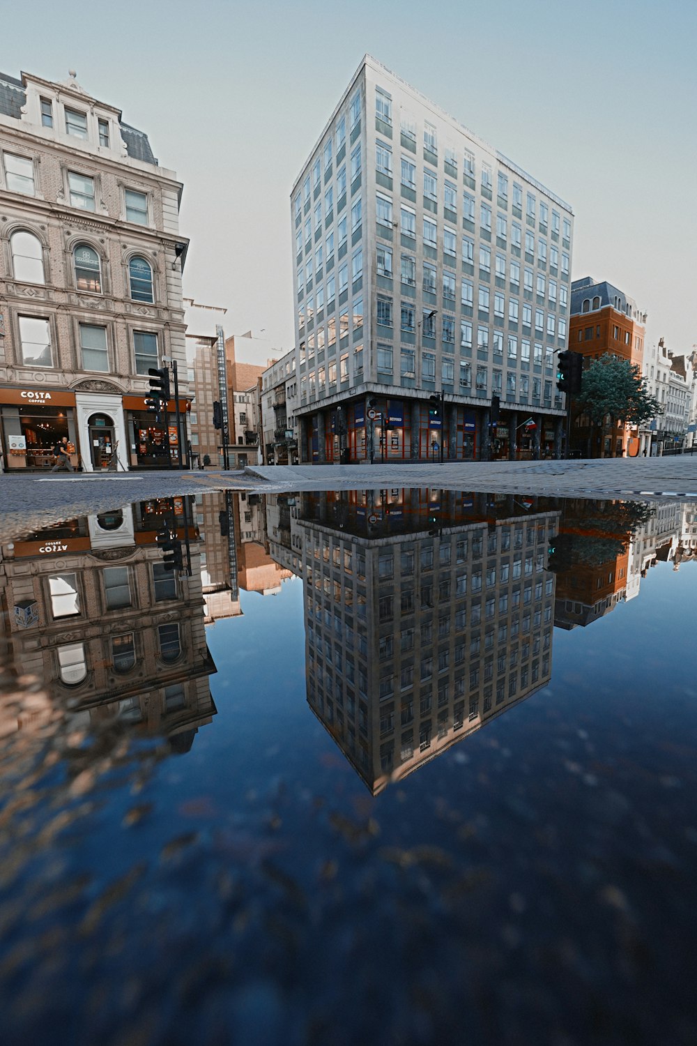 reflection of building on water during daytime