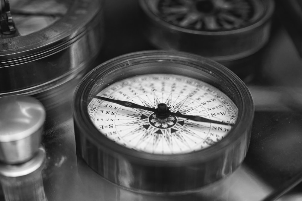 black and white compass in clear glass jar