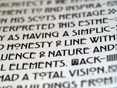 Close-up of a strong, distinctive typeface on a page margin illuminated by warm light.