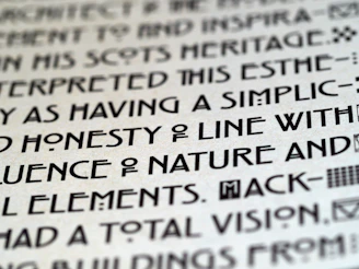 Close-up of an art exhibit label with elegant typography beside a vibrant painting.