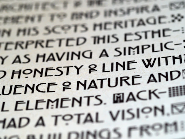 Close-up of an art exhibit label with elegant typography beside a vibrant painting.