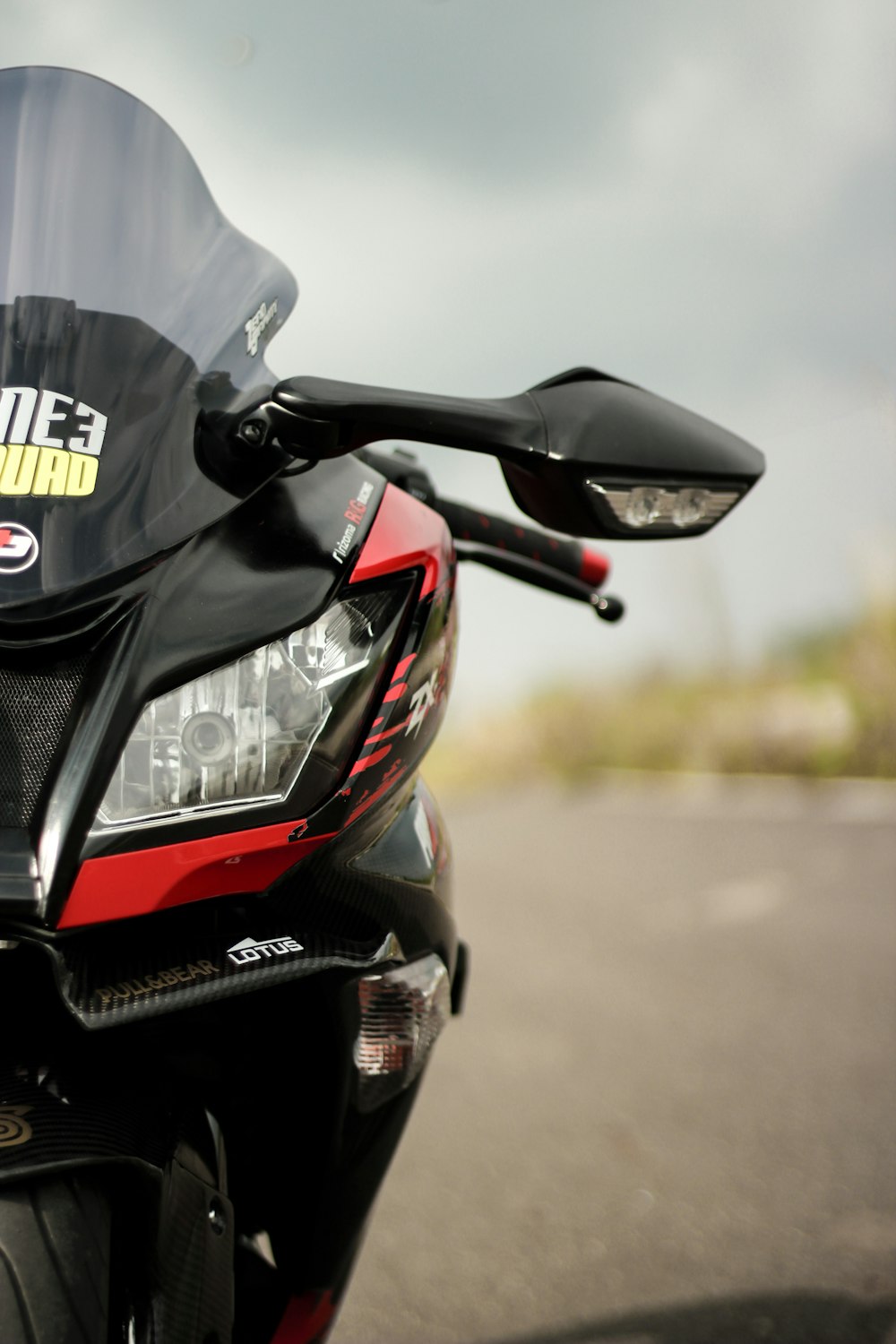 a red and black motorcycle parked on the side of the road