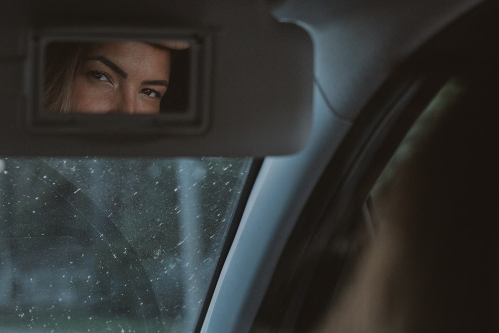 man in car taking selfie