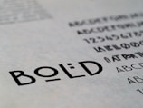 Text featuring the word 'BOLD' in a clear, sans-serif font. Surrounding the main focus are additional alphabet characters and numbers, suggesting a typographic or design context.