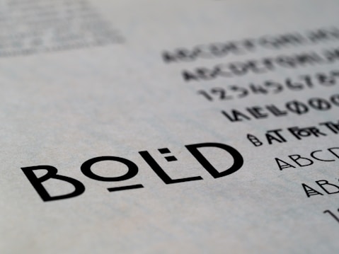 Text featuring the word 'BOLD' in a clear, sans-serif font. Surrounding the main focus are additional alphabet characters and numbers, suggesting a typographic or design context.