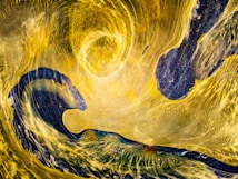 A swirling abstract composition with a dynamic interplay of bright yellow and deep blue colors. The design features fluid, wave-like patterns giving a sense of motion and energy, with textures that resemble brush strokes or flowing currents.