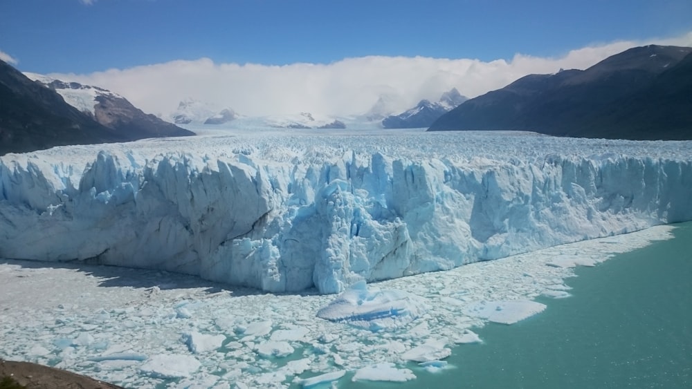 white ice formation on body of water during daytime