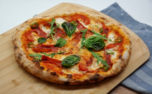 pizza with green leaves and red sauce