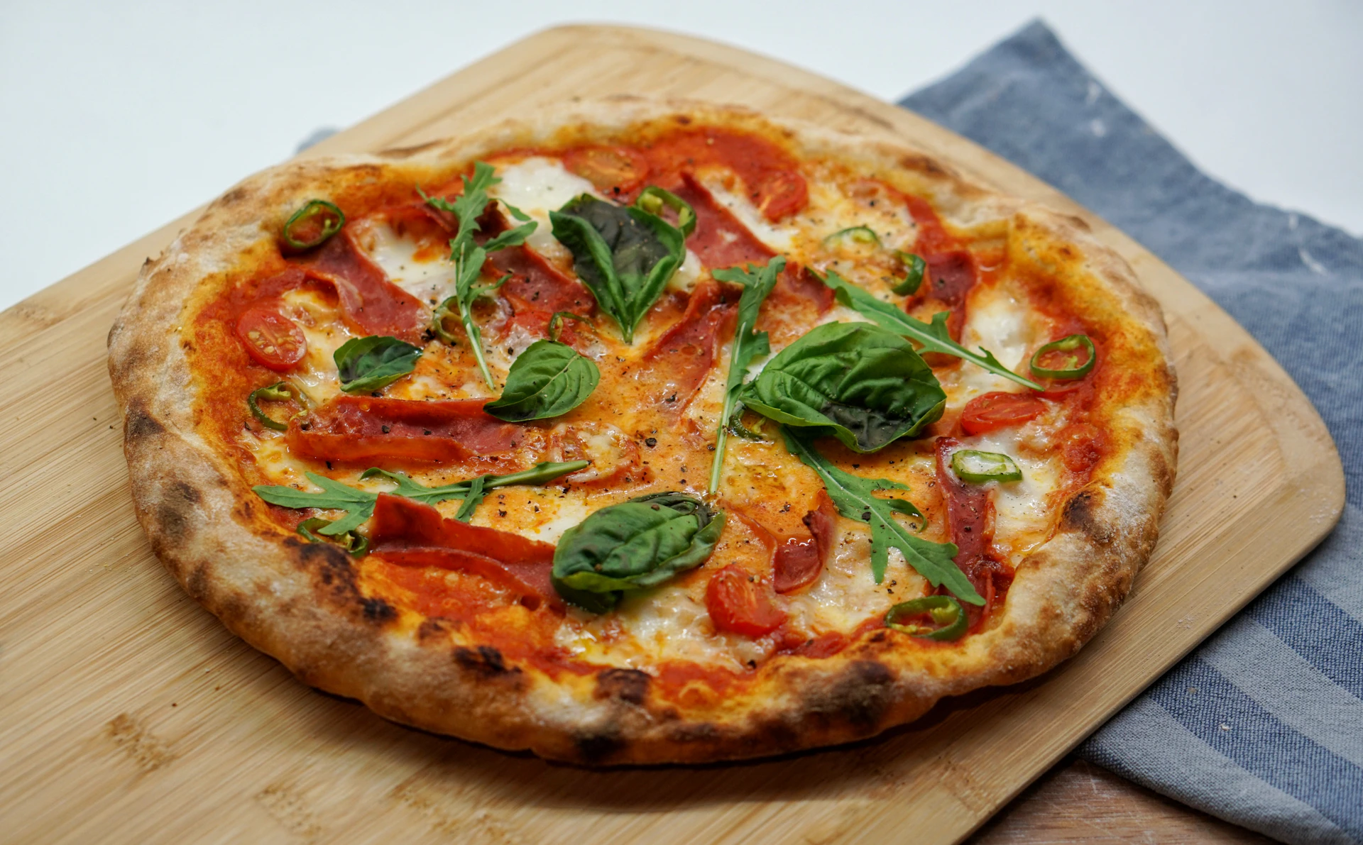 pizza with green leaves and red sauce