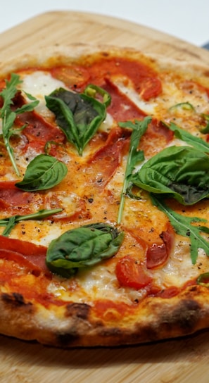 pizza with green leaves and red sauce