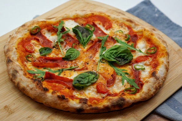 pizza with green leaves and red sauce