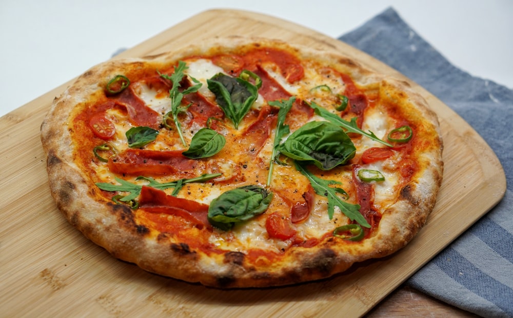 pizza with green leaves and red sauce