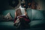 woman in red shirt reading book